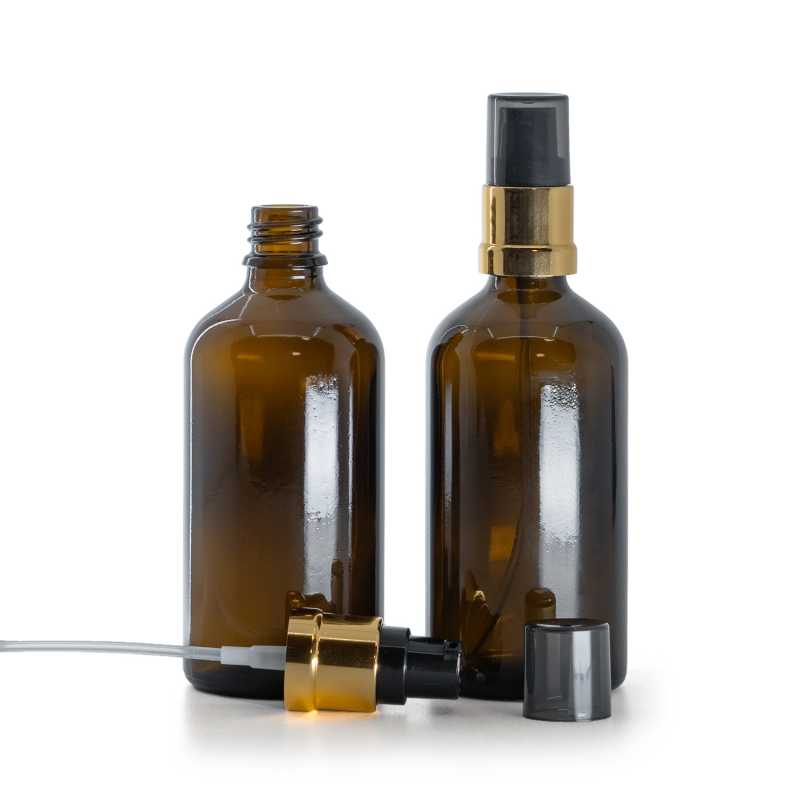 Flacone di vetro ambra, pompa lucida nero-oro con sopra-tappo fumé, 100 ml